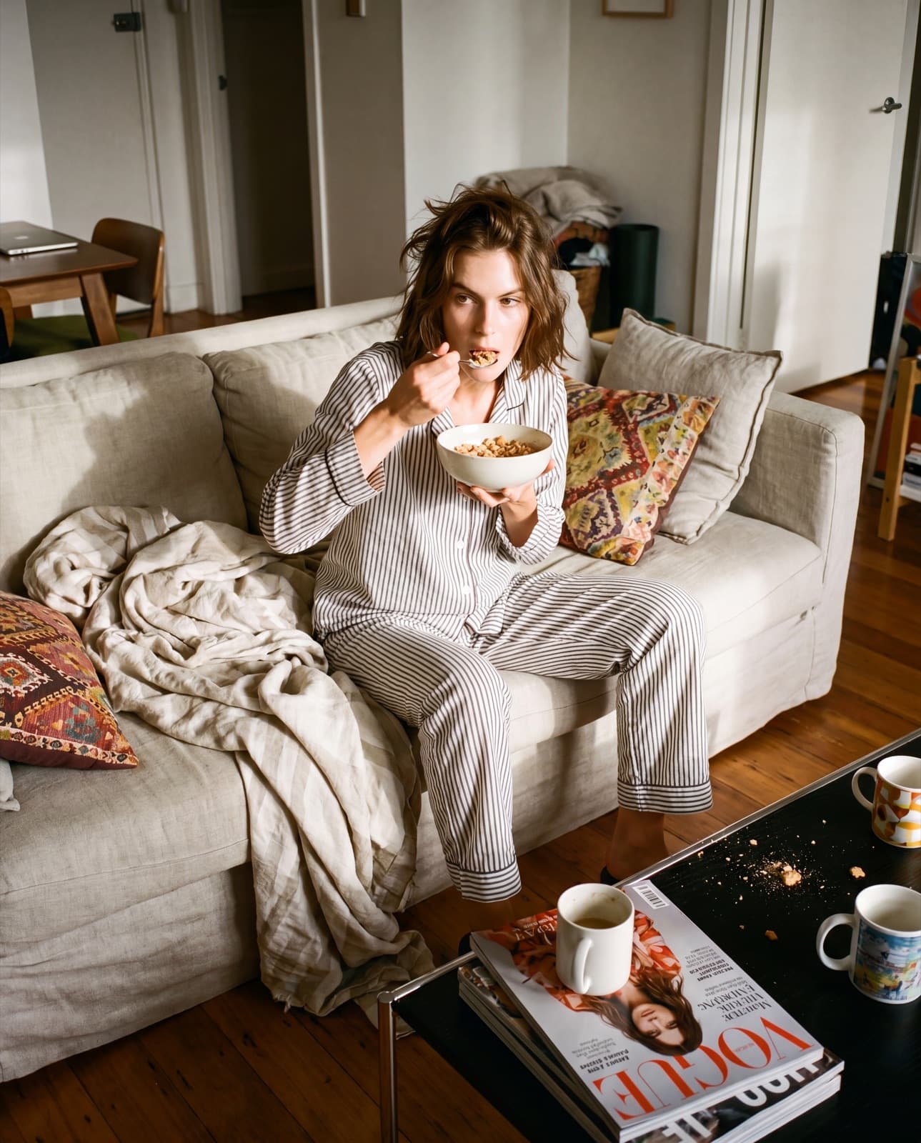 Sunday morning — cereal bowl on couch, lived-in apartment